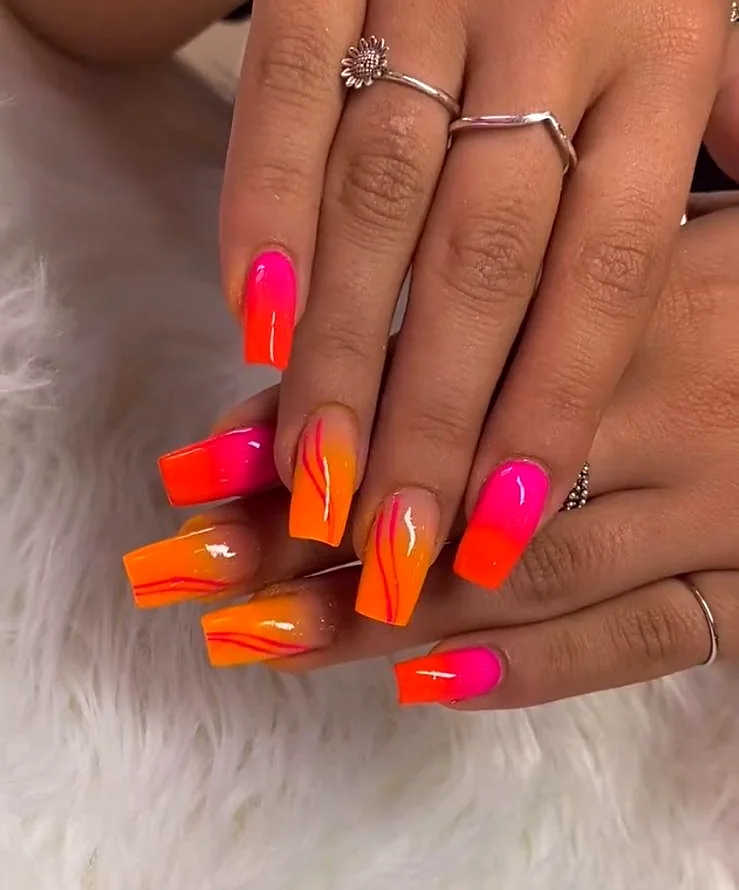 Unghie squadrate sfumate dal fucsia all'arancio con righe sottili